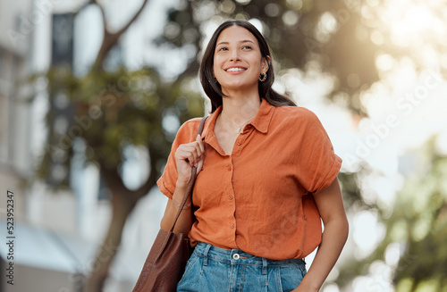 Stylish, happy and trendy student walking in a city, commuting to a college and enjoying a weekend break downtown. Smiling, edgy or funky woman exploring, visiting and enjoying town while sightseeing
