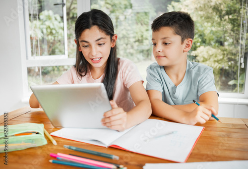 Kids studying education with digital tablet for online school work or homework together at home. Intelligent distance learning students, children or siblings of brother and sister help with lesson.