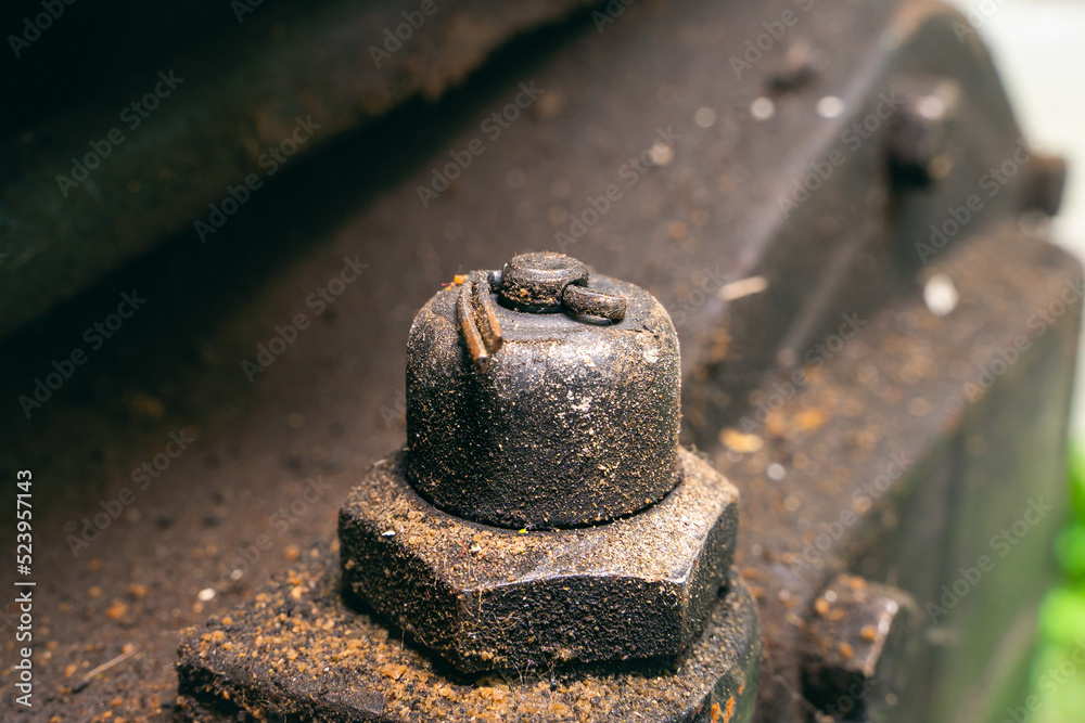 Old oil pressure sensor on a walk-behind tractor close-up on the engine. Dirty diesel engine body in sticky mud. The pin holds the oil sensor Old oil pressure sensor on a walk-behind tractor close-up on the engine. Dirty diesel engine body in sticky mud. The pin holds the oil sensor