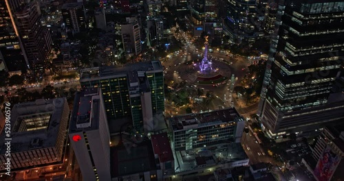 Mexico City Aerial v1 hyperlapse birds eye view of illuminated angel of independence on paseo de la reforma, tilt up reveals lit up downtown cityscape at dusk - Shot with Mavic 3 Cine - December 2021 photo