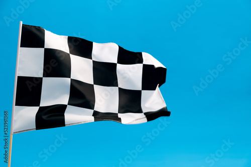 Checkered flag waving on blue background