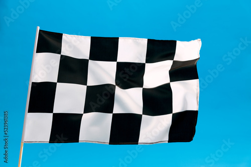 Checkered flag waving on blue background © xy