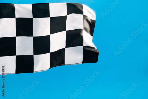 Checkered flag waving on blue background
