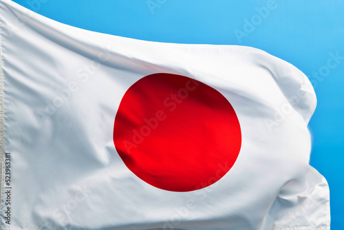 Japan flag waving on blue background photo