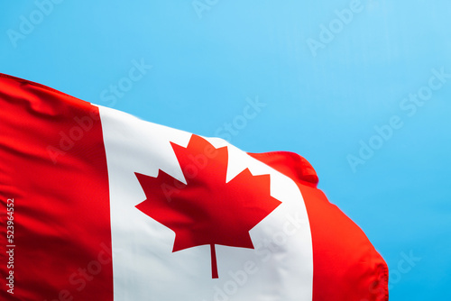 Canada flag waving on blue background