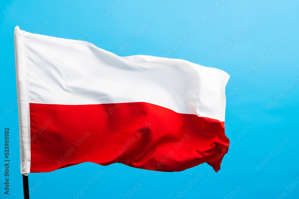 Poland flag waving on blue background Poland flag waving on blue background