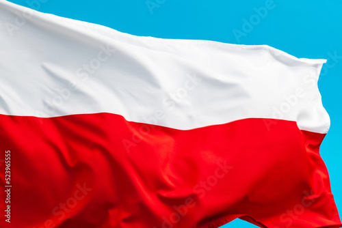 Poland flag waving on blue background