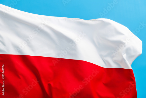 Free Download Poland flag waving on blue background - GFXLoad
