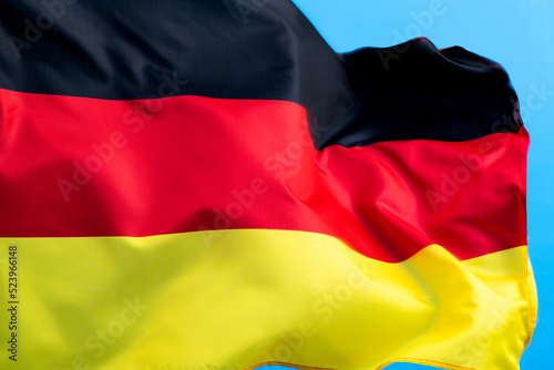 Germany flag waving on blue background