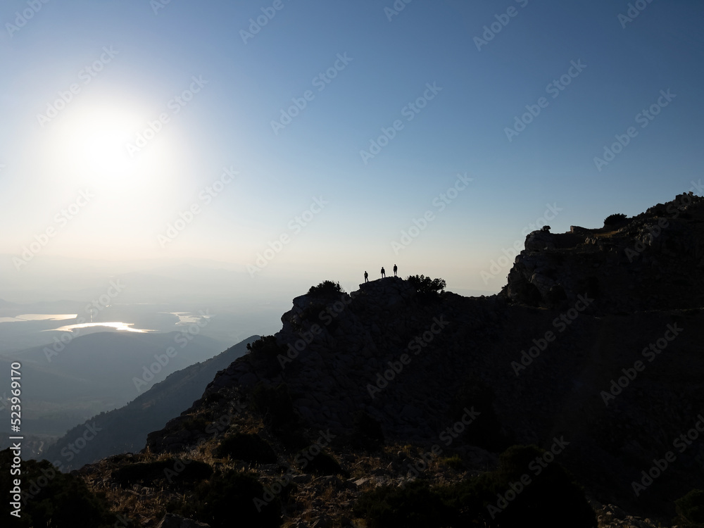 group of successful mountaineers in majestic high-altitude mountains watching landscape