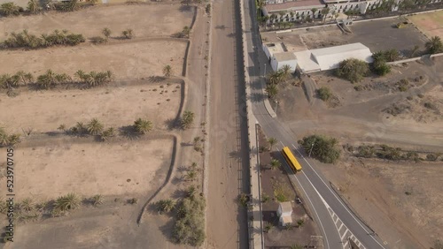 Aerial View Of Coastal Village Of Tarajalejo With Soccer Field And Hotels In Fuerteventura Island, Las Palmas, Spain. Atlantic Ocean Revealed. drone tilt-up photo