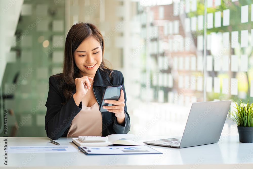 Asian business woman working in finance with laptop and smartphone, accounting concept. Asian business woman working in finance with laptop and smartphone, accounting concept.