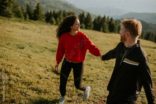 Smiling couple walking with...