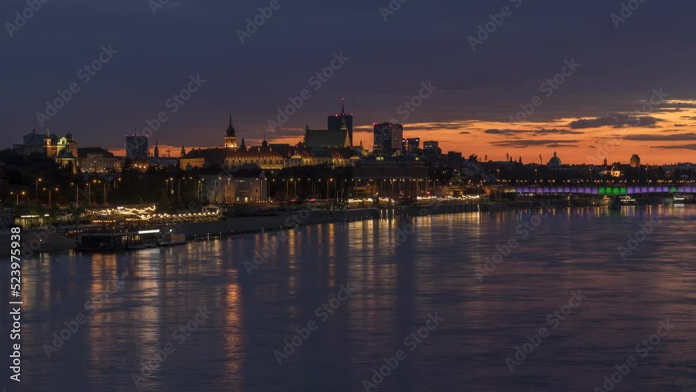 Timelaspe of the golden sunset above the river and the old town with lights reflected in the river Timelaspe of the golden sunset above the river and the old town with lights reflected in the river