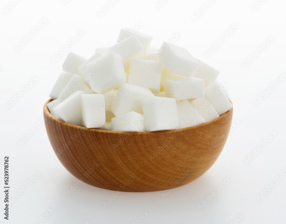 Sugar cubes in a bowl on white background Sugar cubes in a bowl on white background