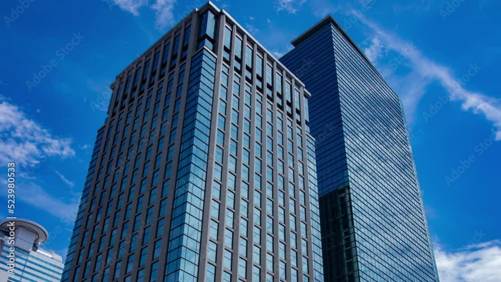 A timelapse of cloud reflecting the building in the business town wide shot panning