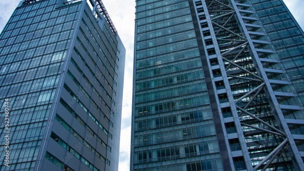 A timelapse of cloud reflecting the building in the business town wide shot panning A timelapse of cloud reflecting the building in the business town wide shot panning