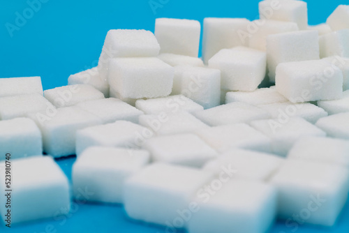 Sugar cubes on blue background