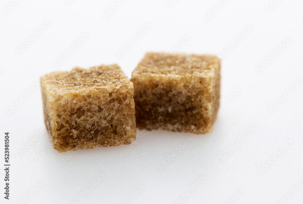 Brown sugar cubes on white background Brown sugar cubes on white background