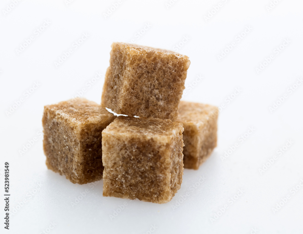 Brown sugar cubes on white background