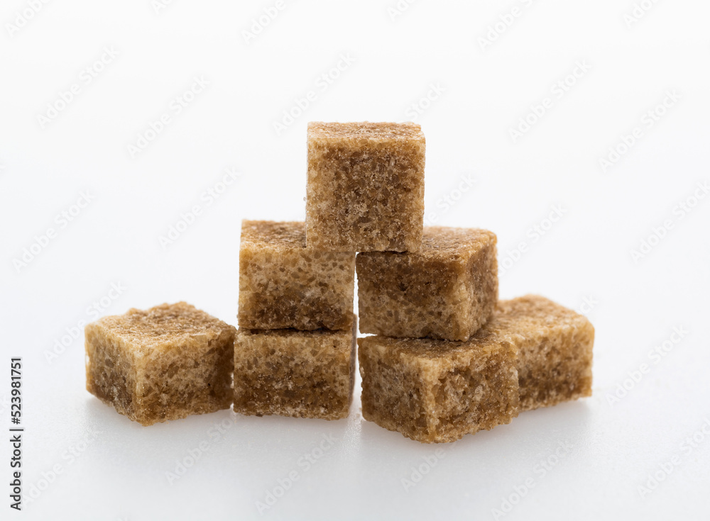 pile of brown sugar cube on white background pile of brown sugar cube on white background