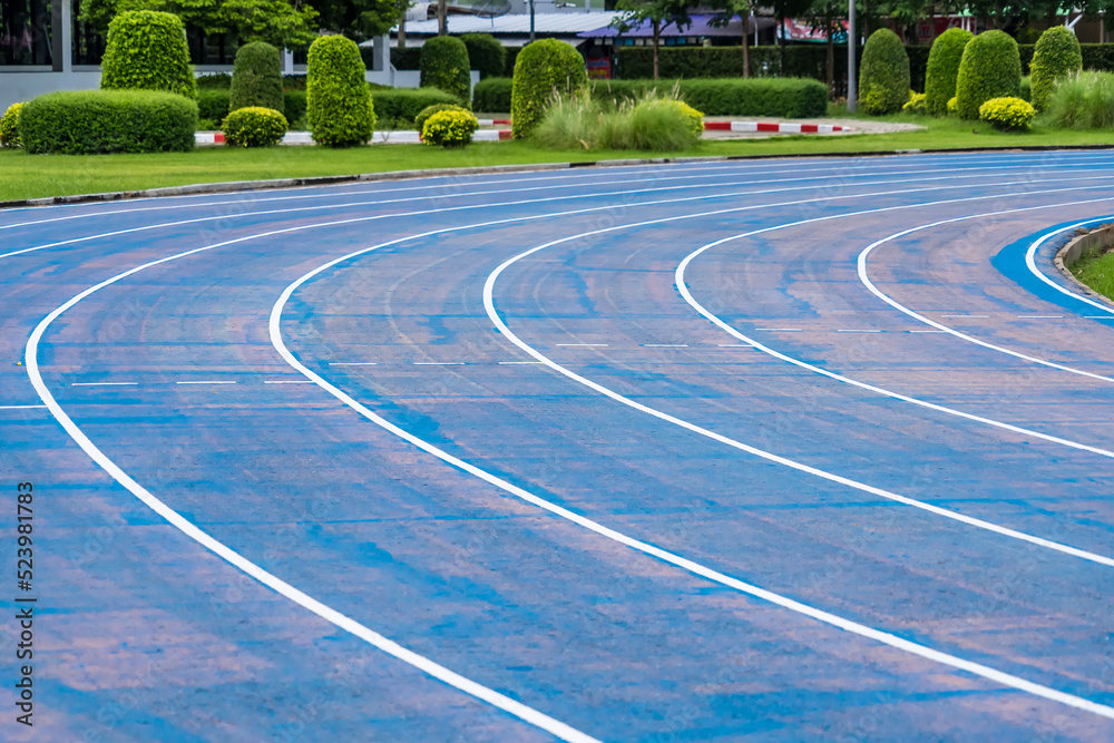 background of blue track for running competition at stadium, focus on center.