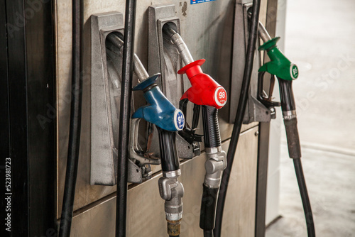 Three fuel dispenser nozzles at petrol pump photo