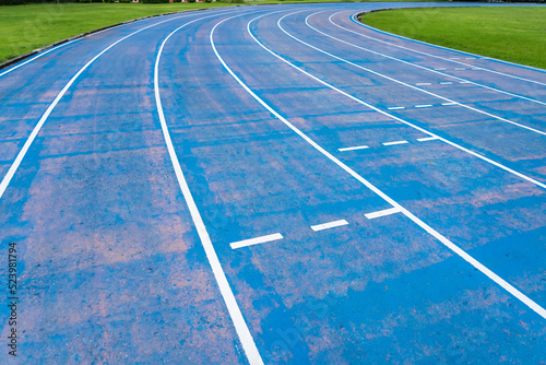 background of blue track for running competition at stadium  focus on center.