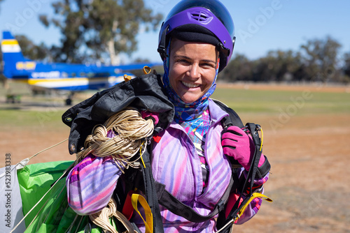 female skydiver walking back from drop zone after a jump