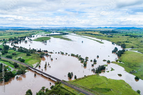 Brown floodwaters covering farmland near Singleton, NSW, Australia