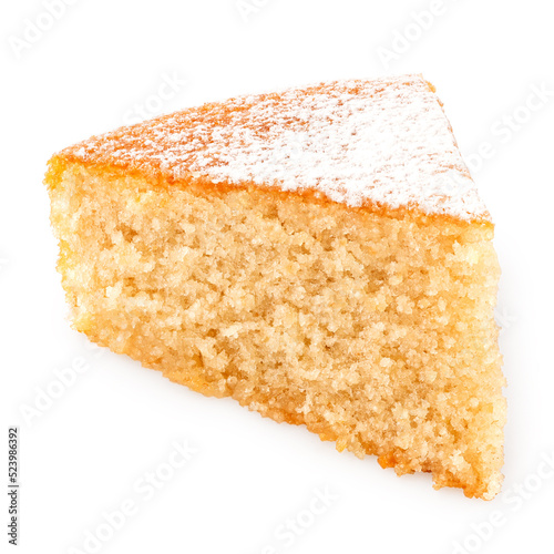 Wedge of lemon sponge cake with icing sugar topping isolated on white.