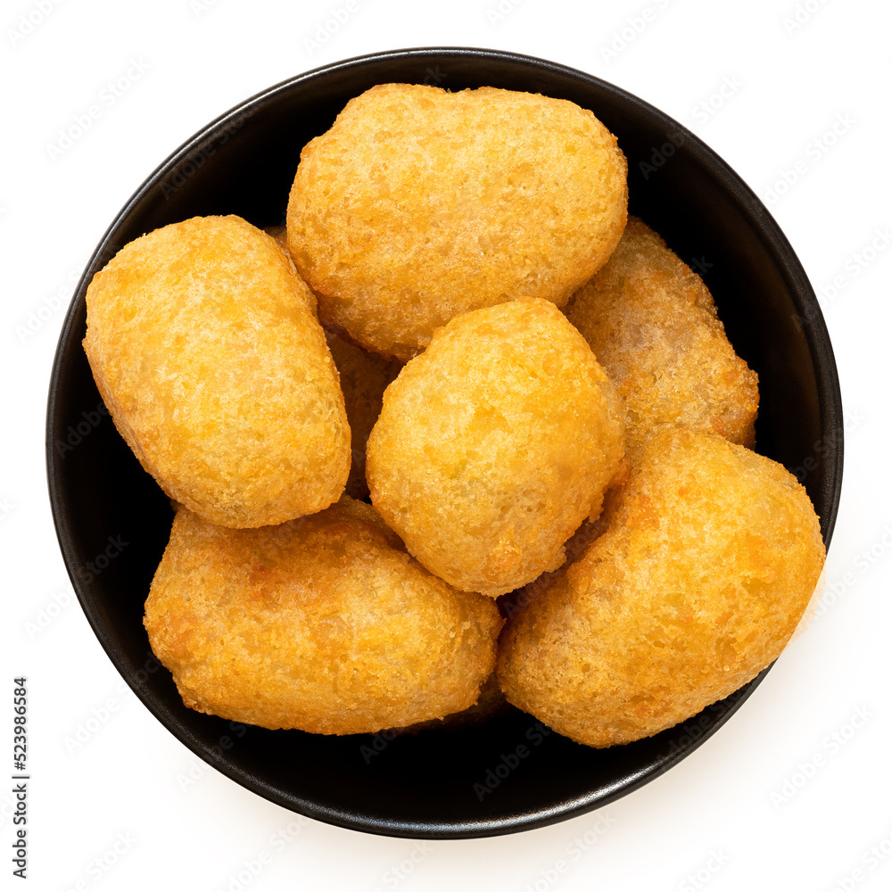 Fried breaded chilli cheese nuggets in a black ceramic bowl isolated on white from above.