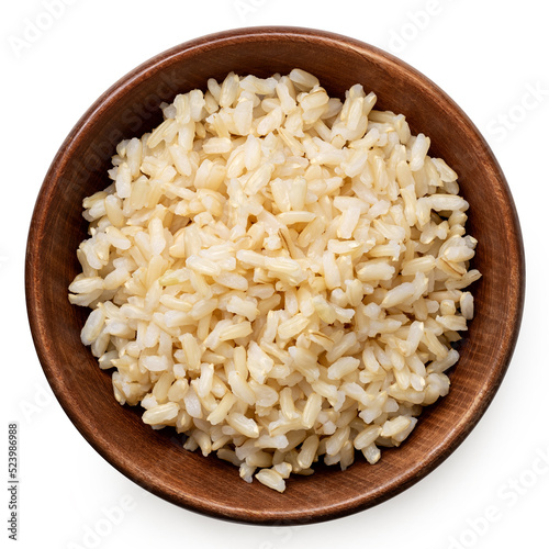 Valokuva Brown cooked rice in a brown wood bowl isolated on white from above