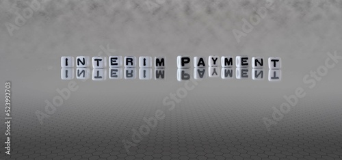 Fotografi interim payment word or concept represented by black and white letter cubes on a