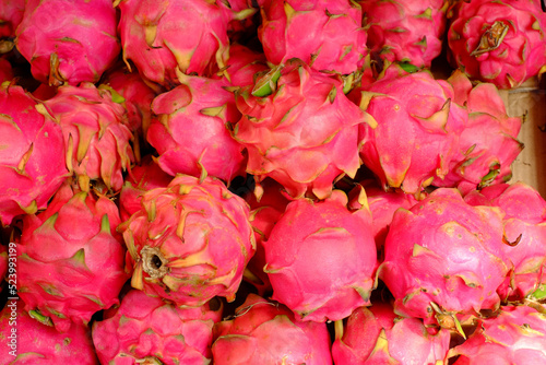 Red dragon fruits can be sweet or sour. Their thick scales protect a white flesh stuffed with tiny seeds that is eaten fresh.