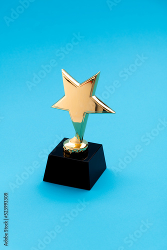 Golden star trophy on blue background