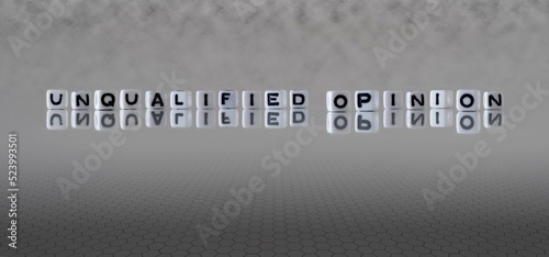 unqualified opinion word or concept represented by black and white letter cubes on a grey horizon background stretching to infinity