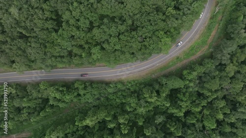 Top down aerial zoom out footage of a curvy road in the mountains in southern Virigina. photo