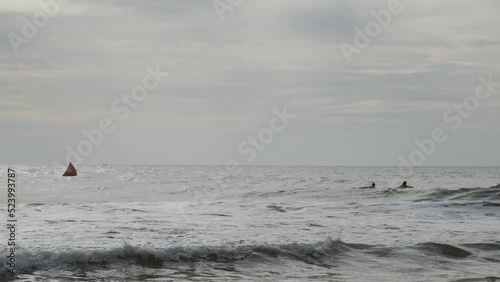 Surfers in action during a bright sunny day. photo