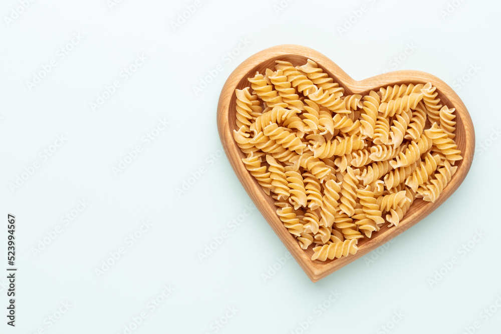 Pasta in a heart shaped wood bowl. Pasta in a heart shaped wood bowl.