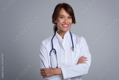 Studio portrait of middle aged female doctor