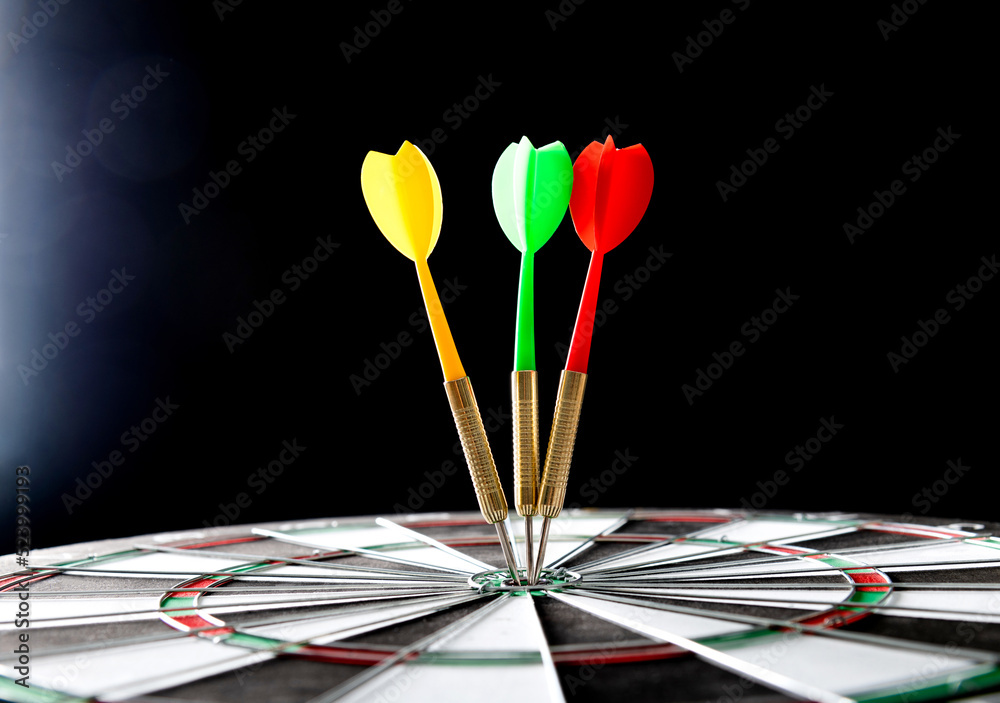 Three darts hitting on center target Three darts hitting on center target