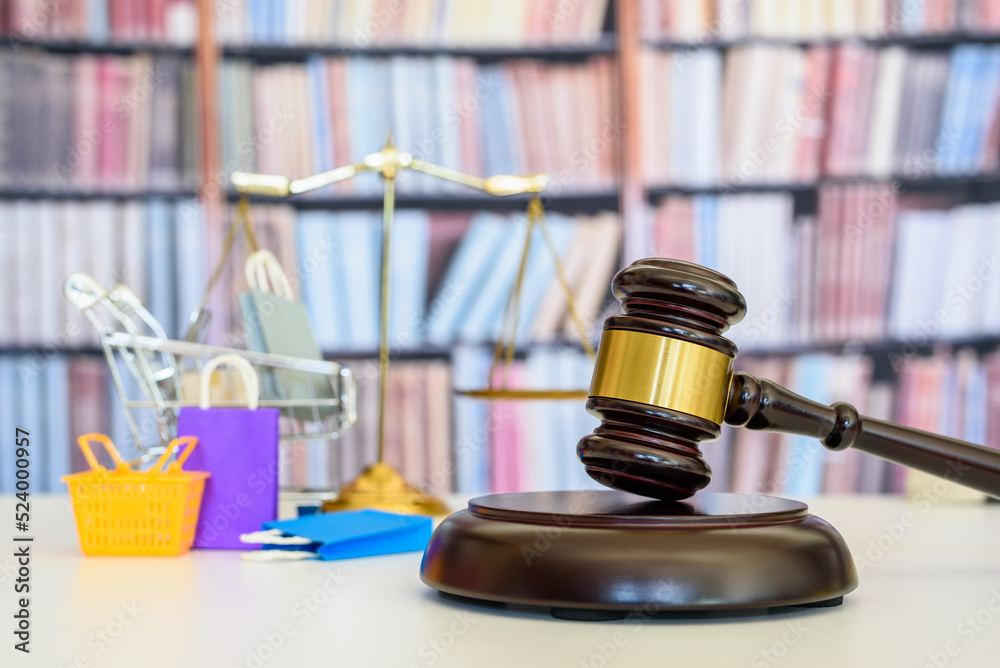 Consumer protection law, rights and guarantees, justice concept : Judge gavel, balance scale, bags, a shopping cart, depicting a safeguard designed to protect buyers from fraudulent business practices - obrazy, fototapety, plakaty 