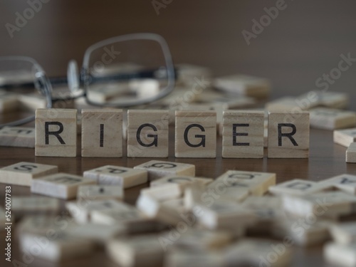 Fotografi Rigger word or concept represented by wooden letter tiles on a wooden table with