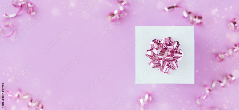 gift box with festive confetti on pastel light pink background top view with place for advertising text	
