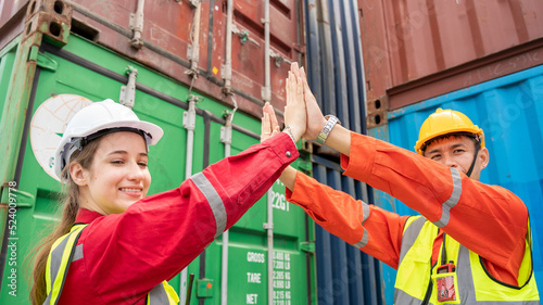 Success Woman manager and foreman Trust hand Hi Five hand after success project logistics business in front of Cargo concainer in warehouse , Manager in white helmet Safety Supervisor 
