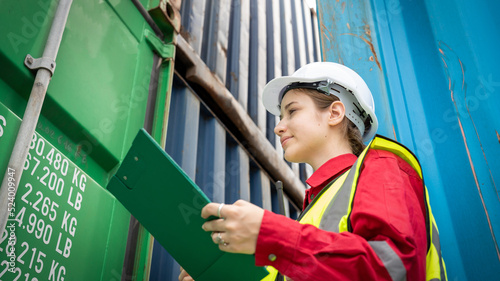 Woman inspector foreman Checking Cargo in Container cargo CustomTerminal port, Foerman use Clipboard paper for checking cargo concept import export transportation and logistic insurance service