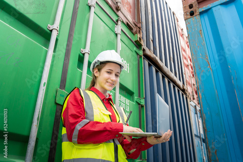 Woman inspector foreman Checking Cargo in Container cargo CustomTerminal port, Foerman use Laptop for checking cargo concept import export transportation and logistic insurance service