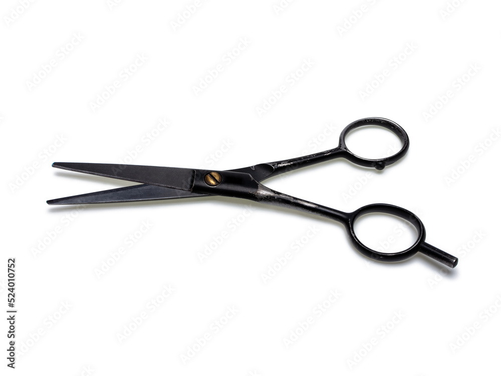 Old professional barber scissors in black. Isolated on white background Old professional barber scissors in black. Isolated on white background