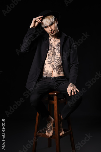 Young tattooed man sitting ...
